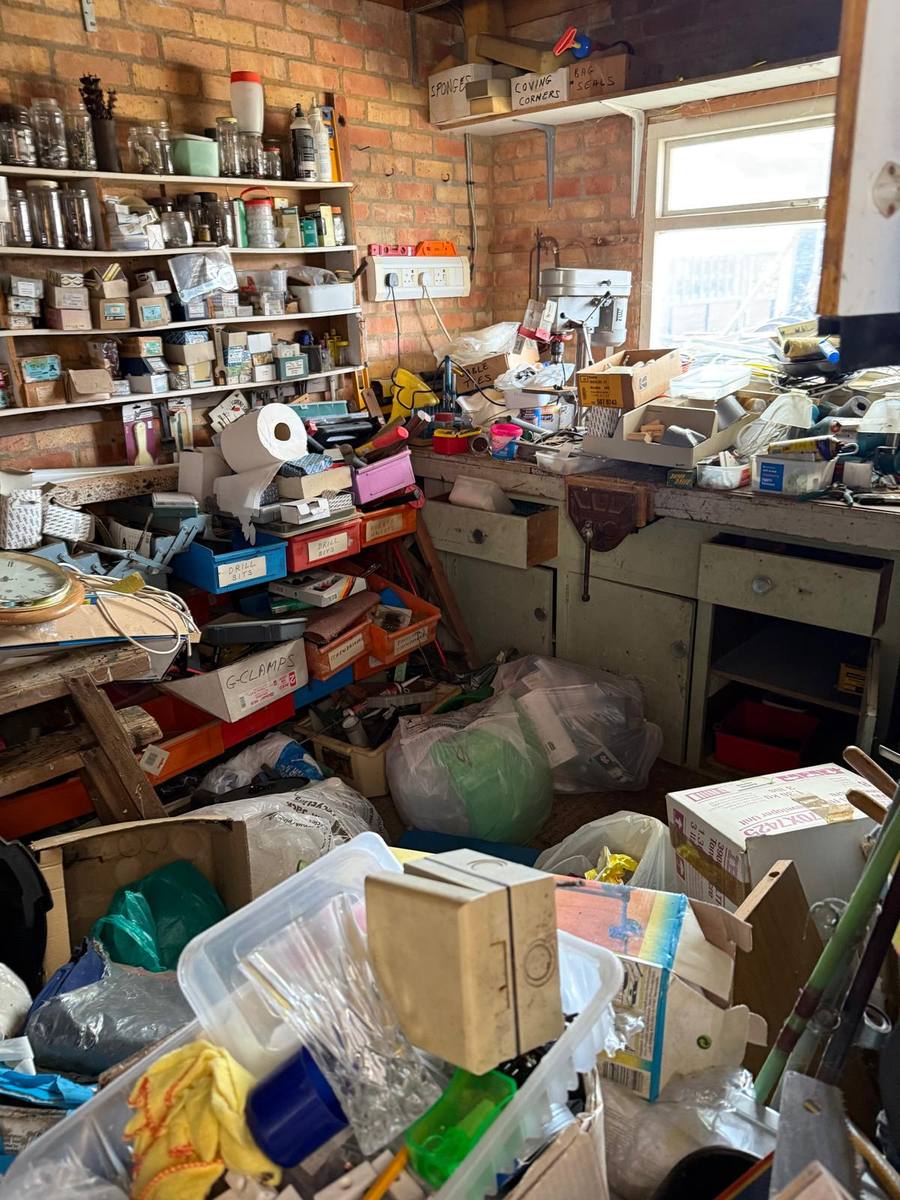 Cluttered garage workshop before clearance